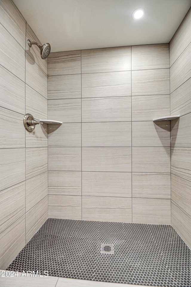 bathroom with tiled shower