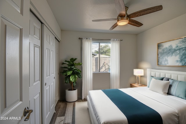 bedroom featuring hardwood / wood-style flooring, ceiling fan, and a closet