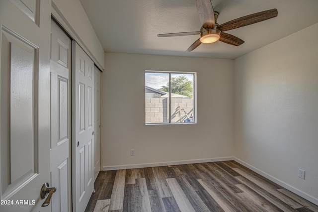 unfurnished bedroom with hardwood / wood-style flooring, a closet, and ceiling fan