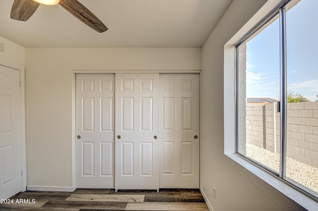 unfurnished bedroom with a closet and dark hardwood / wood-style floors