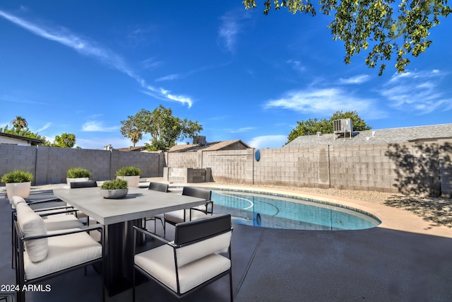 view of swimming pool with a patio and central AC