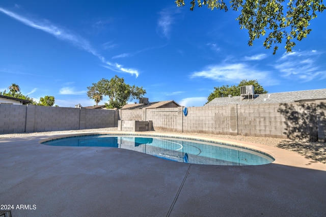 view of swimming pool with central AC and a patio