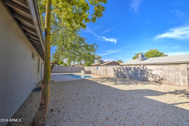 view of yard with a fenced in pool and a patio area