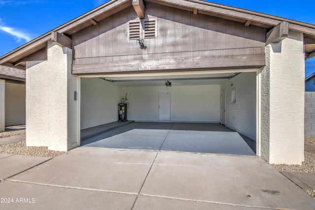 garage with a garage door opener and water heater