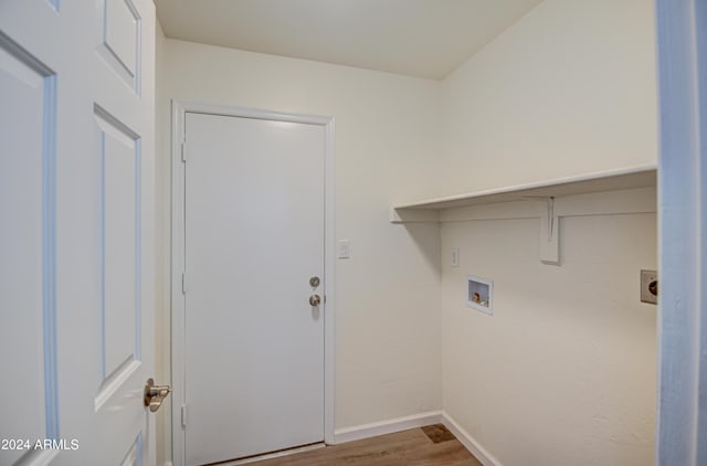 washroom with hookup for a washing machine, wood-type flooring, and electric dryer hookup