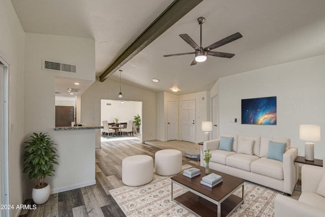 living room with vaulted ceiling with beams, light hardwood / wood-style floors, and ceiling fan