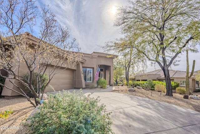 pueblo revival-style home featuring a garage