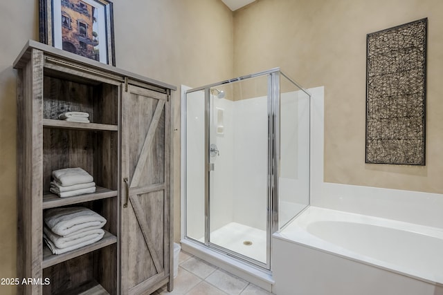 bathroom featuring tile patterned flooring and independent shower and bath