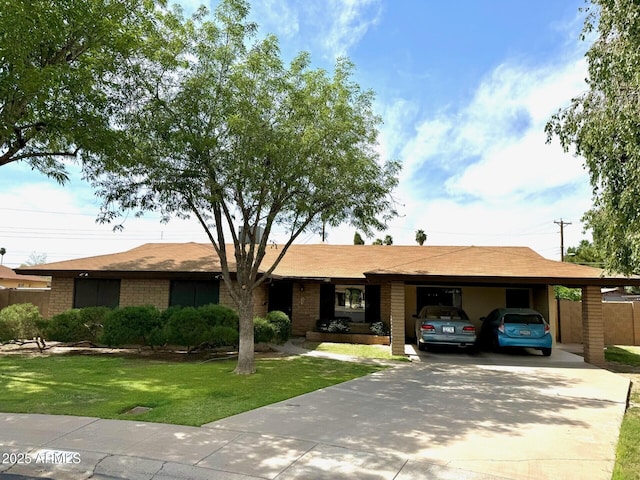 ranch-style home with a carport, brick siding, driveway, and a front yard