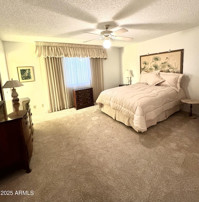 bedroom with carpet flooring, a textured ceiling, and ceiling fan