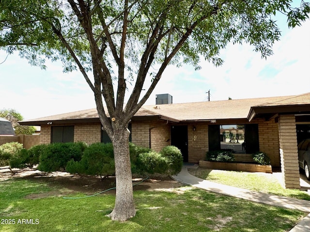 single story home with a shingled roof and a front lawn