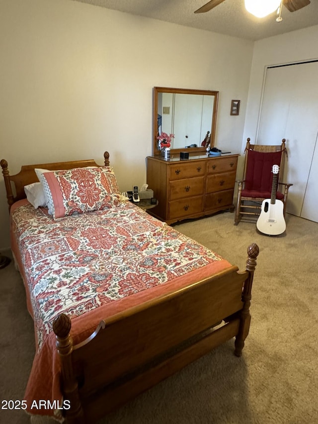 bedroom featuring light carpet and a ceiling fan
