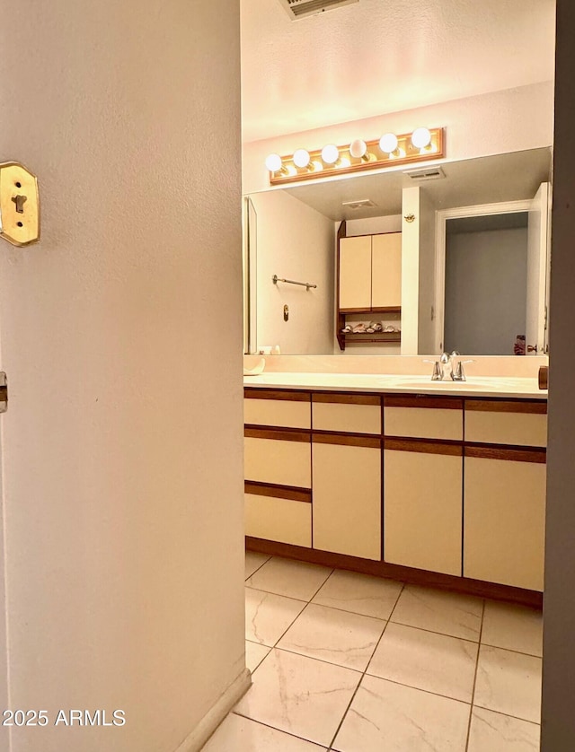bathroom with visible vents, baseboards, and vanity