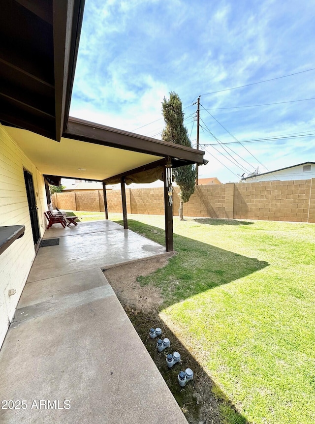 view of yard with a fenced backyard and a patio