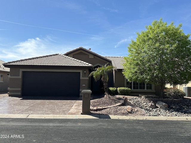 15075 W Amelia Dr, Goodyear, AZ 85395 - view of front of property with a tile roof, stucco siding, a garage, and driveway