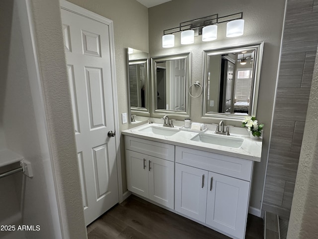 15075 W Amelia Dr, Goodyear, AZ 85395 - full bathroom featuring double vanity and wood finished floors