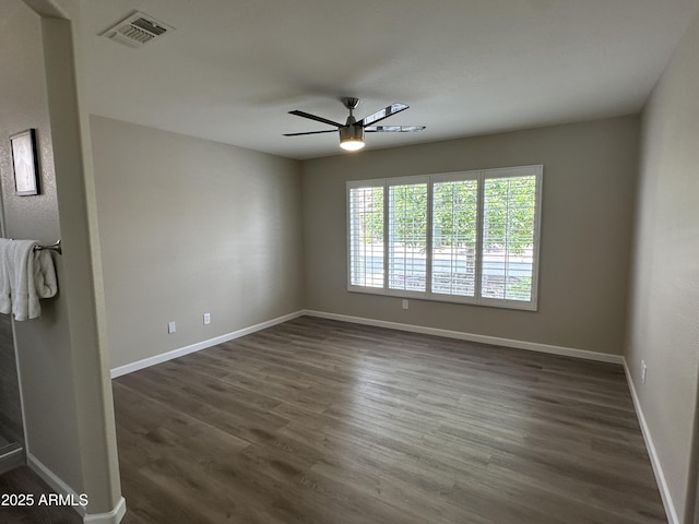 15075 W Amelia Dr, Goodyear, AZ 85395 - empty room featuring ceiling fan and dark wood-style flooring