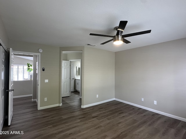 15075 W Amelia Dr, Goodyear, AZ 85395 - spare room with ceiling fan and dark wood-type flooring
