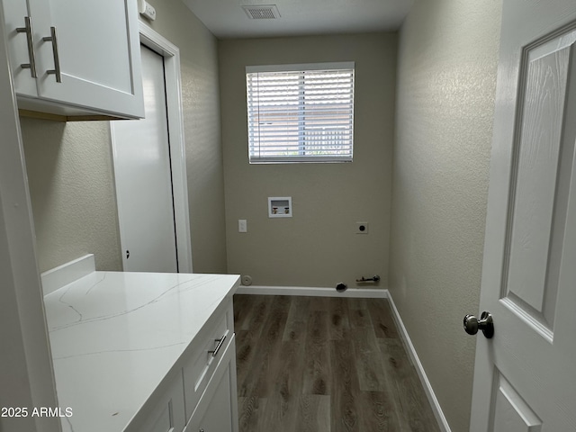 15075 W Amelia Dr, Goodyear, AZ 85395 - laundry room featuring washer hookup, electric dryer hookup, dark wood finished floors, and cabinet space