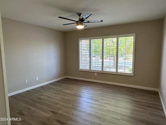 empty room featuring ceiling fan and dark hardwood / wood-style flooring