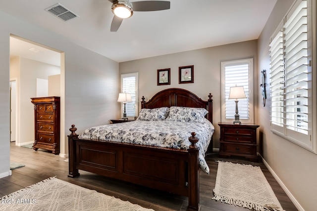 bedroom with ceiling fan and dark hardwood / wood-style flooring