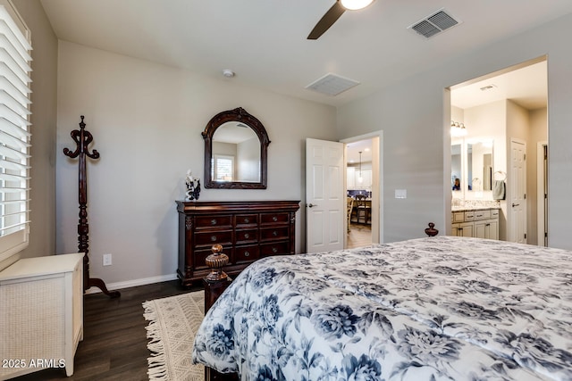 bedroom featuring ensuite bath, ceiling fan, dark hardwood / wood-style flooring, and multiple windows