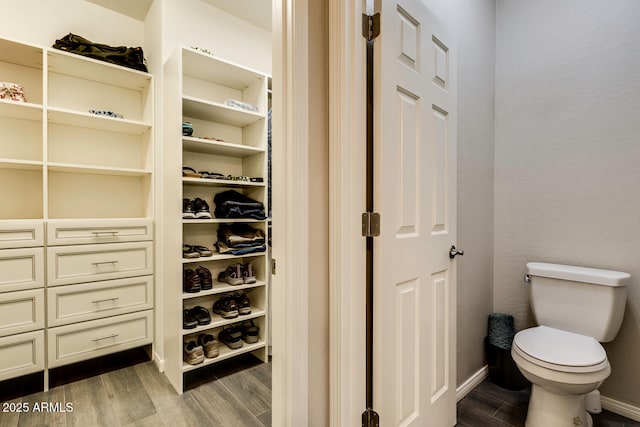 bathroom featuring hardwood / wood-style flooring and toilet