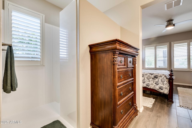 bathroom featuring hardwood / wood-style flooring and ceiling fan