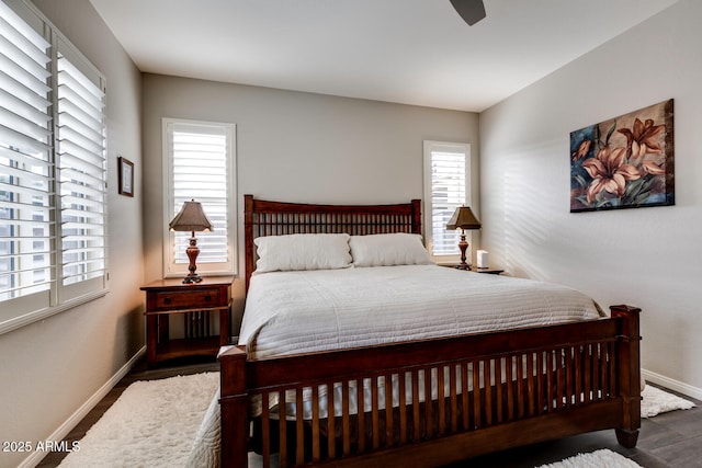 bedroom with ceiling fan and dark hardwood / wood-style floors