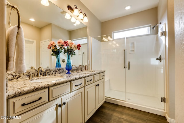 bathroom featuring vanity, hardwood / wood-style flooring, and an enclosed shower