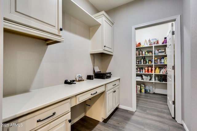 interior space featuring dark hardwood / wood-style floors and built in desk