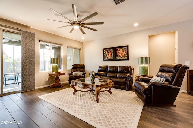 living room featuring dark hardwood / wood-style flooring and ceiling fan