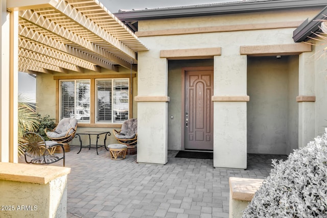 doorway to property with a pergola and a patio area