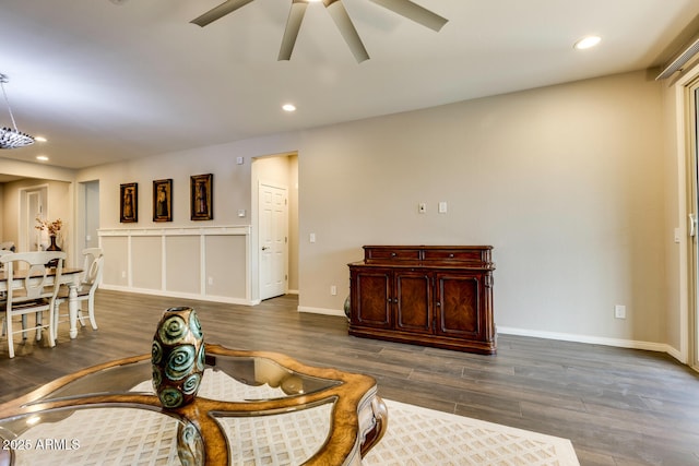 interior space featuring ceiling fan and dark wood-type flooring