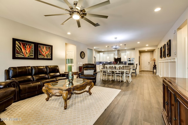 living room with hardwood / wood-style floors and ceiling fan