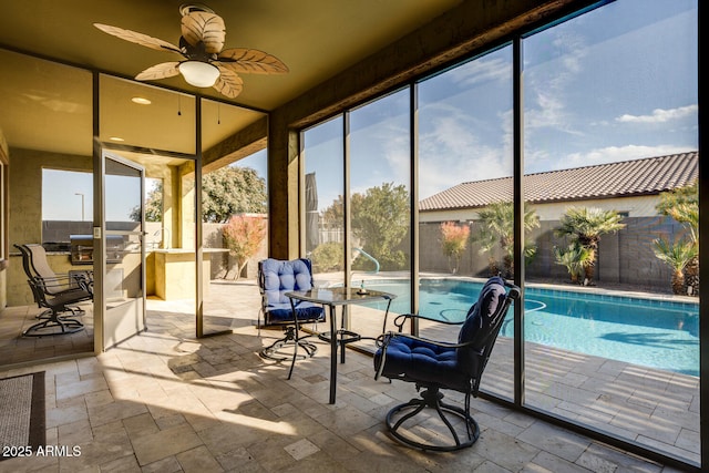 sunroom / solarium featuring ceiling fan