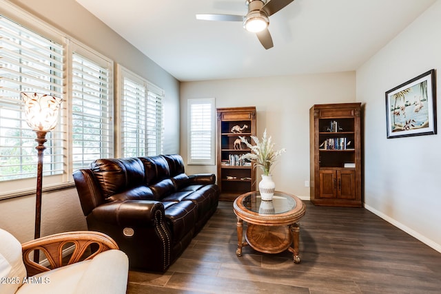 living room with ceiling fan and dark wood-type flooring