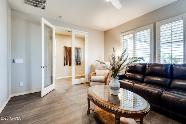 living room with french doors, ceiling fan, and wood-type flooring