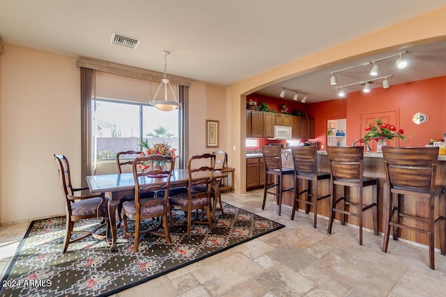 dining room featuring rail lighting