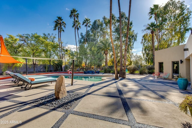 view of pool featuring a patio area, fence, and a fenced in pool