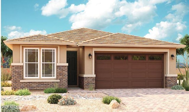 39985 W Anne Ln, Maricopa, AZ 85138 - prairie-style home with stucco siding, decorative driveway, a garage, and stone siding