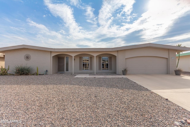 single story home featuring a porch and a garage