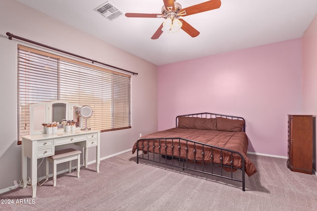 bedroom with ceiling fan and light carpet