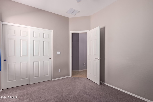 unfurnished bedroom with carpet and a closet