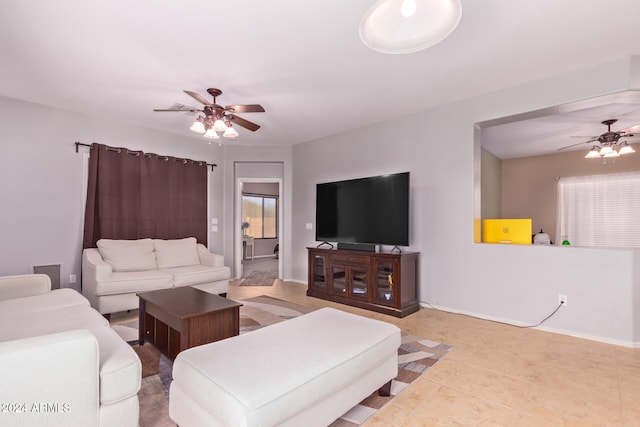 living room with ceiling fan and light tile patterned floors