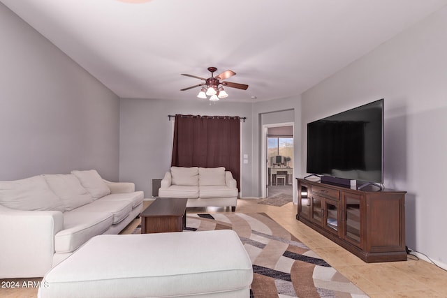 tiled living room featuring ceiling fan