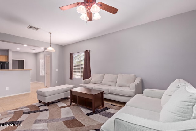 tiled living room featuring ceiling fan