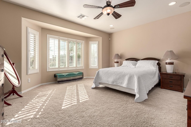 bedroom with light colored carpet and ceiling fan