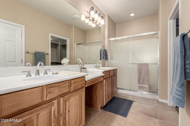 bathroom with tile patterned floors, an enclosed shower, and vanity