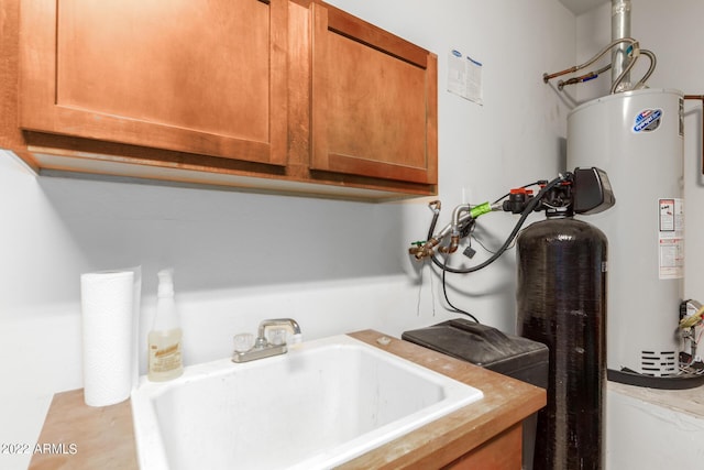 washroom featuring water heater and sink